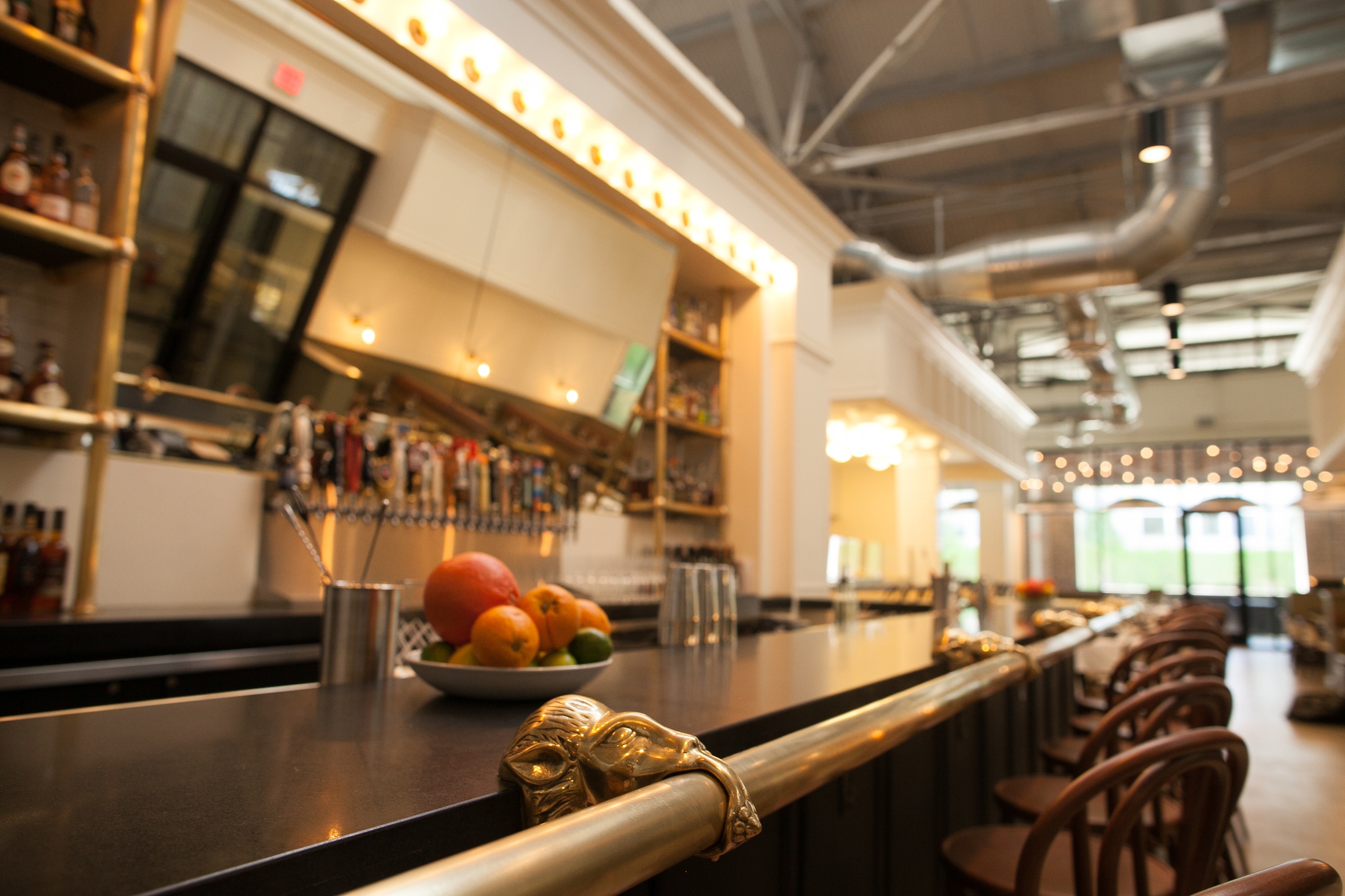 The Luminary’s 3,500-square-foot design is simple and sophisticated, with tiled walls, wood furniture, gleaming lights and a bar that’s situated under 100-year-old trusses.