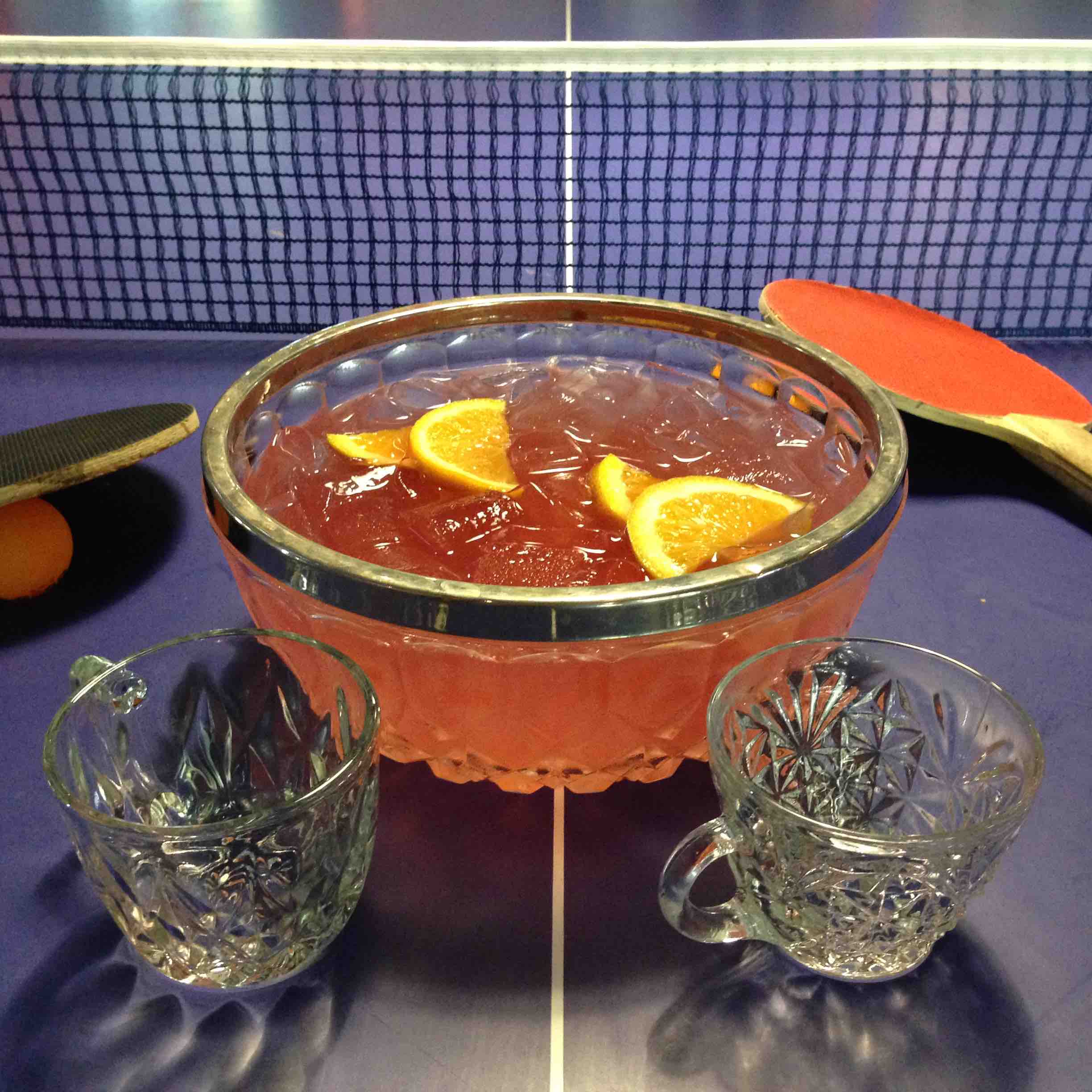 Punch Bowl Social's You Must Bring Us...A Shrubbery! features Skyy Infusions Moscato Grape vodka, house-made watermelon shrub, house-made cardamom syrup, lemon juice, orange slices and a float of Ensemble Red Blend wine.