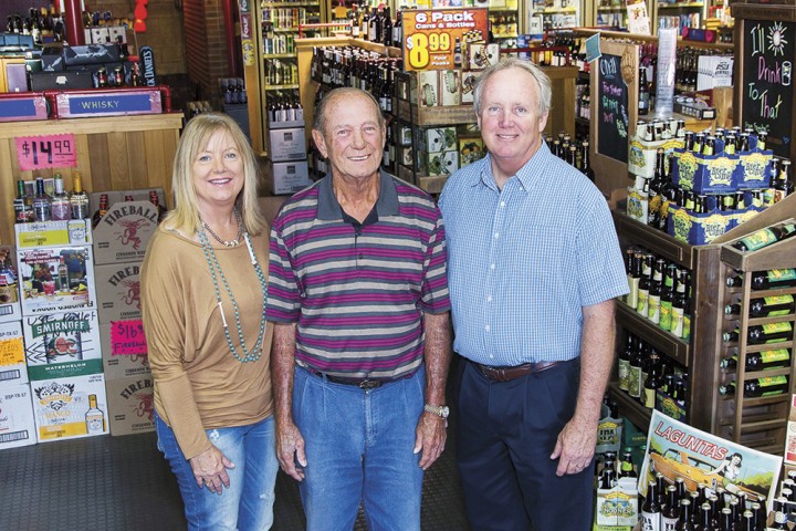 Tops Liquors cofounder Bob Eccles (center) has now retired, leaving co-owners Greg Eccles (right), Trish Ogorek (left) and Lori Eccles DeLoach (not pictured) to run the family business.