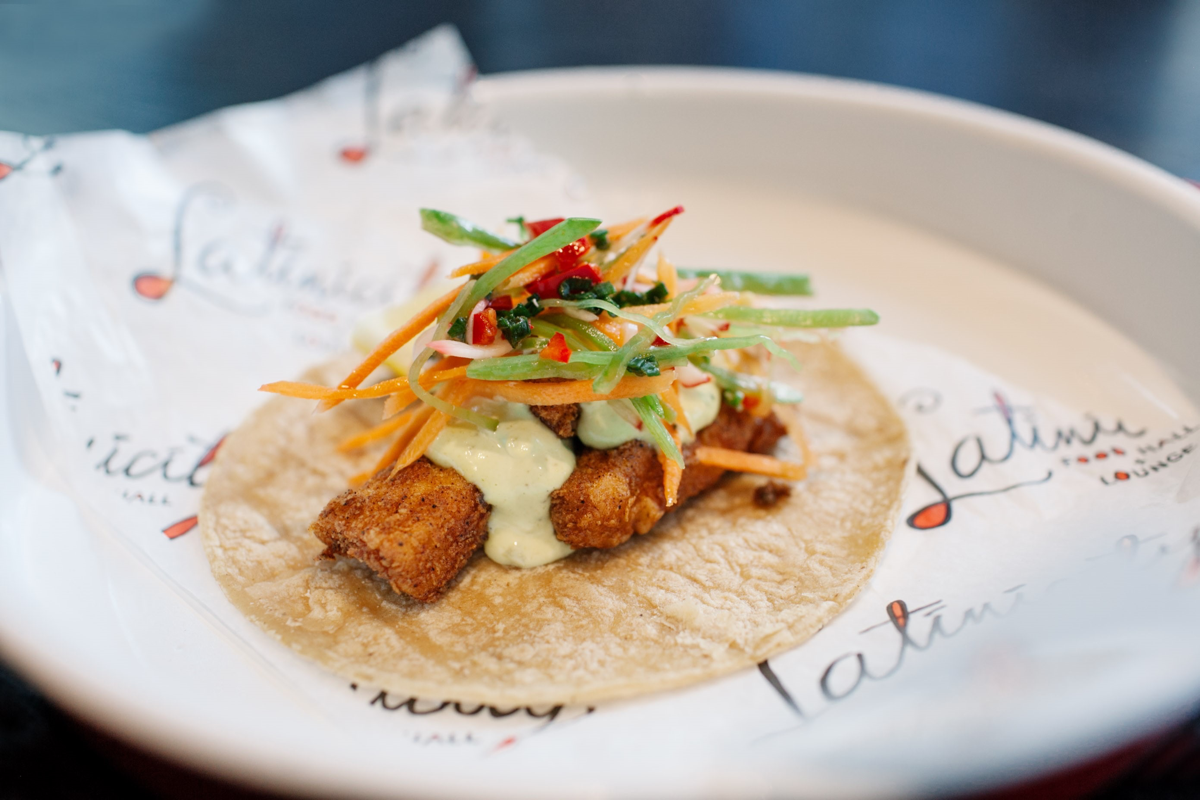 There’s something for everyone at a food hall, which typically houses multiple concepts under one roof. Chicago’s Latinicity offers fish tacos (pictured), as well as sandwiches, sushi and other fare.