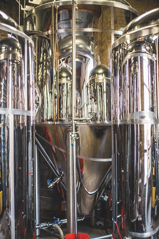 Minnesota's two largest cities share a vibrant beer and spirits culture, exemplified in craft breweries like 612Brew (equipment pictured).