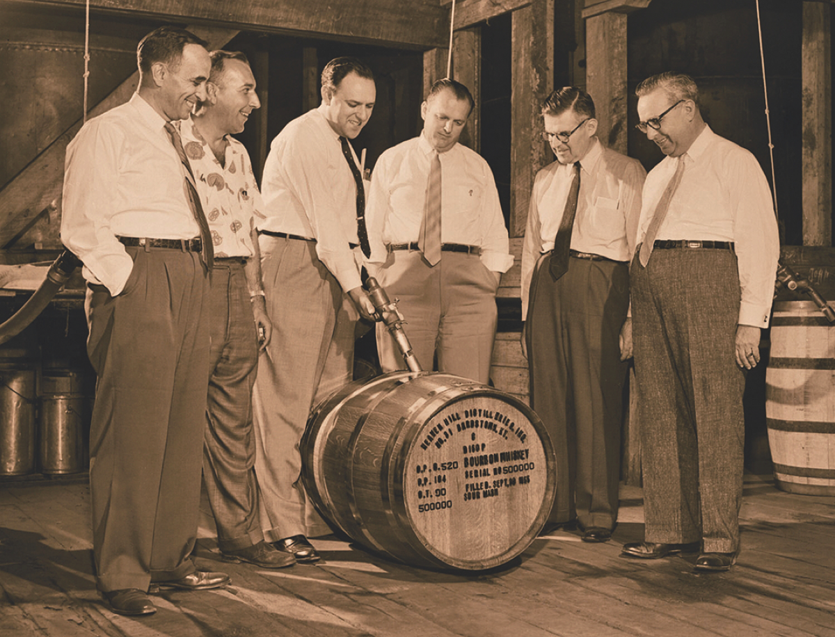 The Shapira brothers, cofounders of Heaven Hill Distillery, fill Bourbon barrel number 500,000 on September 30th, 1955. From left: Ed Shapira, vice president and general manager Charlie DeSpain, David Shapira, Mose Shapira, George Shapira and Gary Shapira.