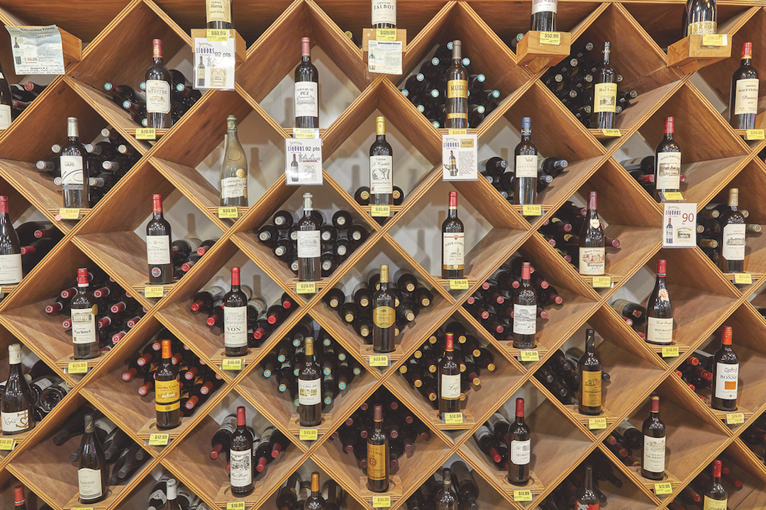 Wine comprises 25% of sales at Jensen's. High-end offerings are displayed in wooden boxes (pictured) on the store's wine wall, which also has a wine closet to hold the most premium bottles.