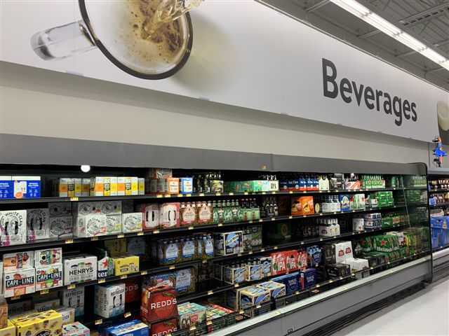 Walmart (East Fishkill, New York beer shelves pictured) is streamlining its e-commerce options for beverage alcohol in 29 states, allowing customers to order on the store website or the Walmart Grocery app.