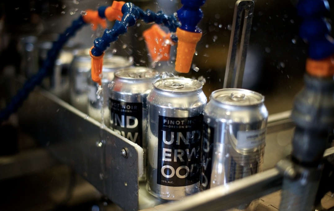 Customers are gravitating toward canned wine brands like Underwood (canning line pictured), House, and Dark Horse thanks to their convenience and portability.