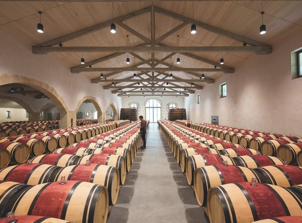 The end of tariffs on French wine and a wealth of options across all price points have aided in Bordeaux’s return to popularity across the country (Château Calon-Ségur barrel room pictured).