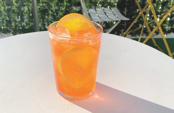 At Sweet Liberty, the Aperol Spritz 2.0 (center) blends Aperol, orange vodka, orange liqueur, orange flower water, saline, orange bitters, Prosecco, and sparkling orange water.