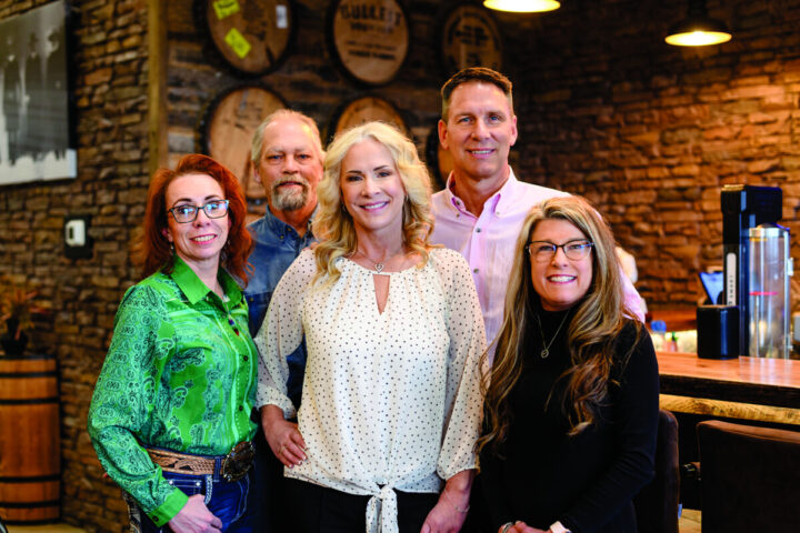 The executive team at Town & Country includes store manager Ted McCleave (back left), general manager Cory Talich (back right), financial officer Gretchen Morrison (front left), owner Laurie Talich (center), and operating manager Bridgette Stubert (front right).