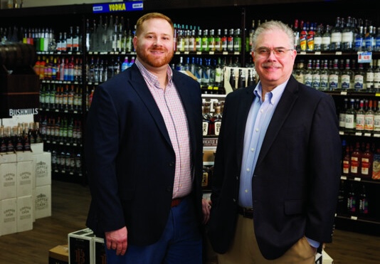 Bob Kreston (right) has worked at his family’s liquor stores for roughly 40 years, following his father into the family business. Now, his son Jeff (left) helps him run the two-unit Kreston Wine & Spirits, which celebrates 100 years in 2033.