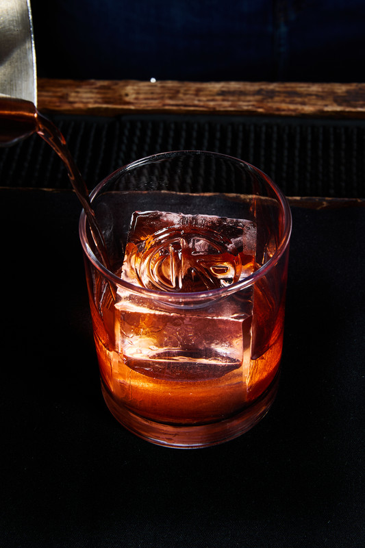 The Regulator mixes pear eau de vie and gin mixed with Sherry, prune-infused Campari, and bitter liqueur.