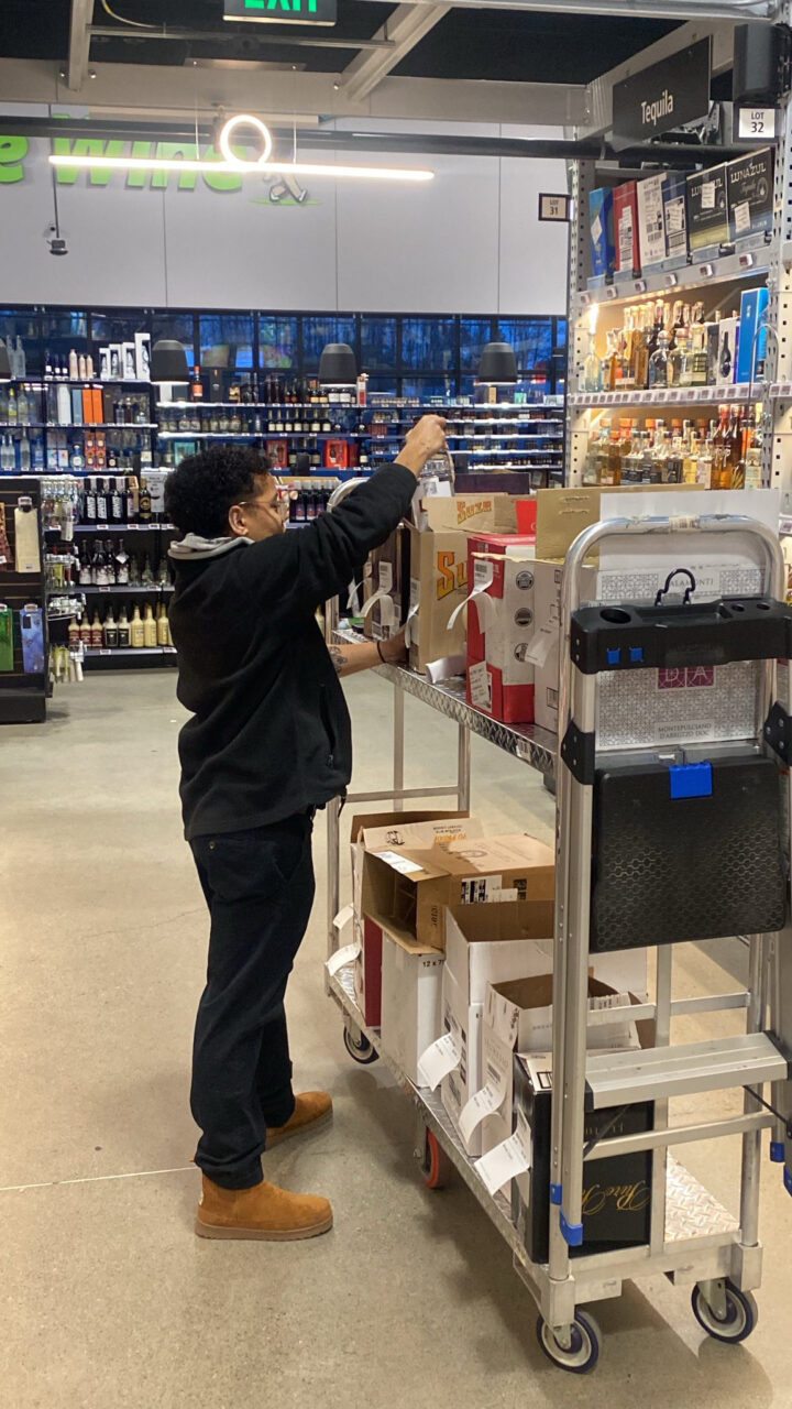 An employee packs boxes with online orders for local delivery at Empire Wine, Albany, New York.