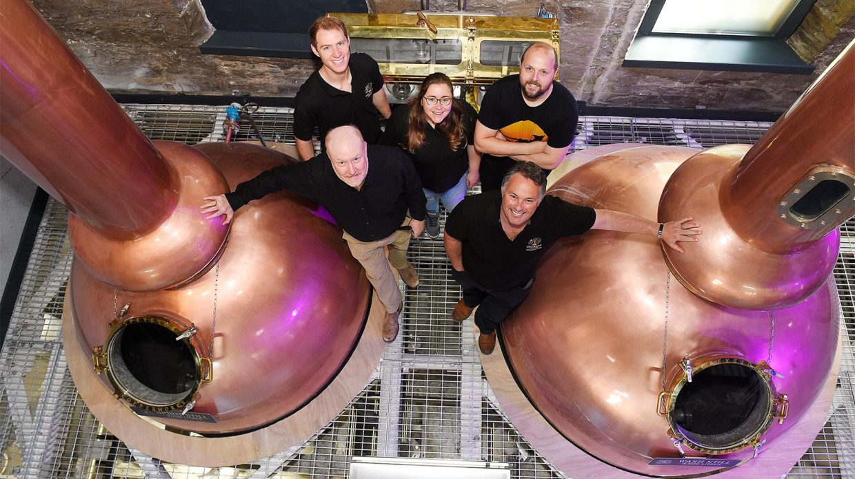 aerial view holyrood distillery staff next to stills
