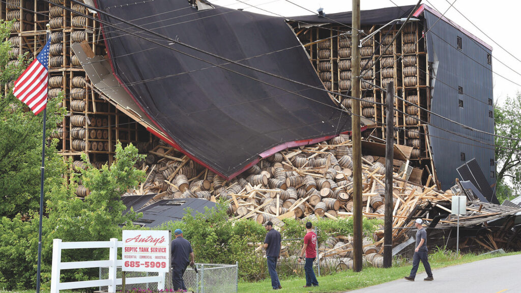 Workers from O.Z. Tyler Distillery look over Warehouse H, which collapsed during a thunderstorm shortly after midnight Monday, on June 17, 2019 in Owensboro, Kentucky.