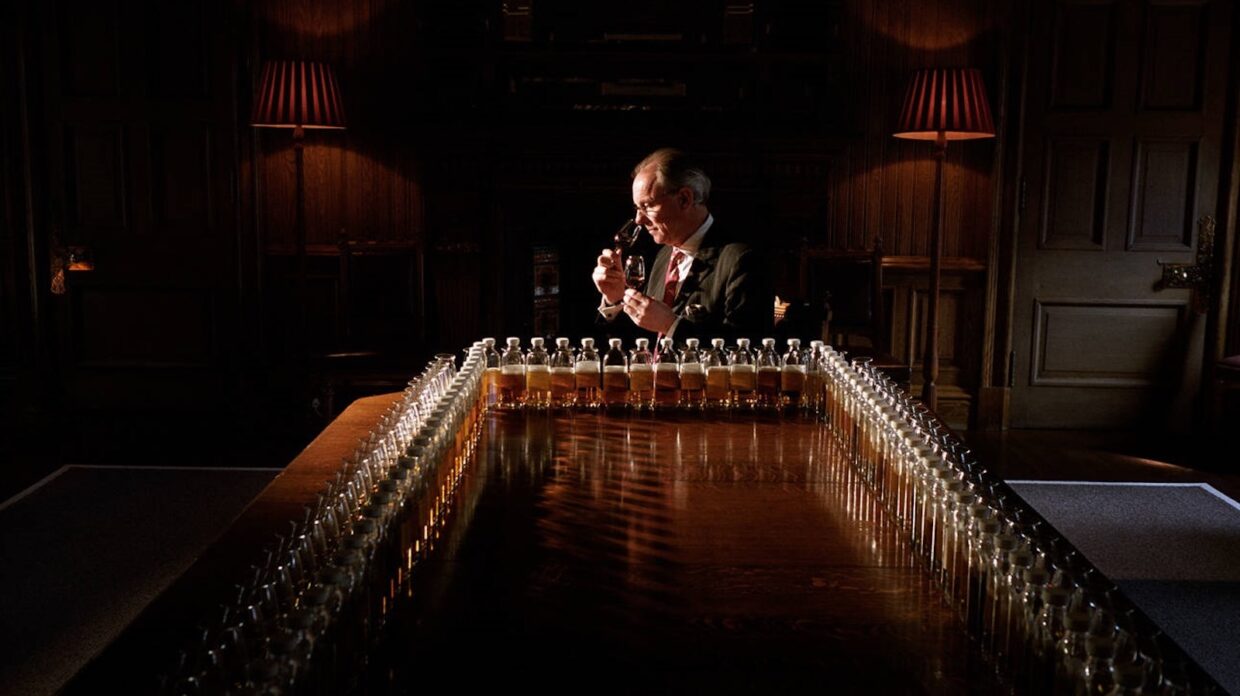 Chivas Brothers master blender Colin Scott noses a glass of whisky at a table filled with sample bottles