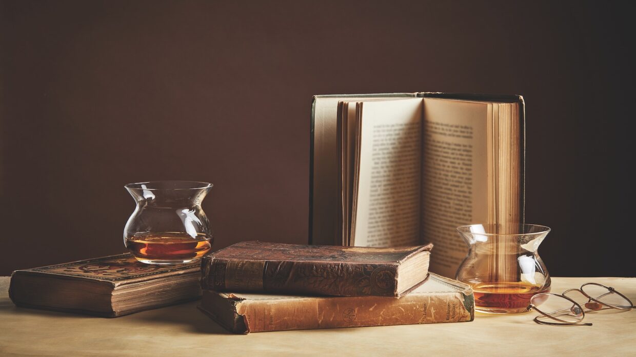 whiskey glasses and old books